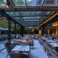 A transparent retractable roof system helps hospitality venues create flexible all-weather outdoor spaces.