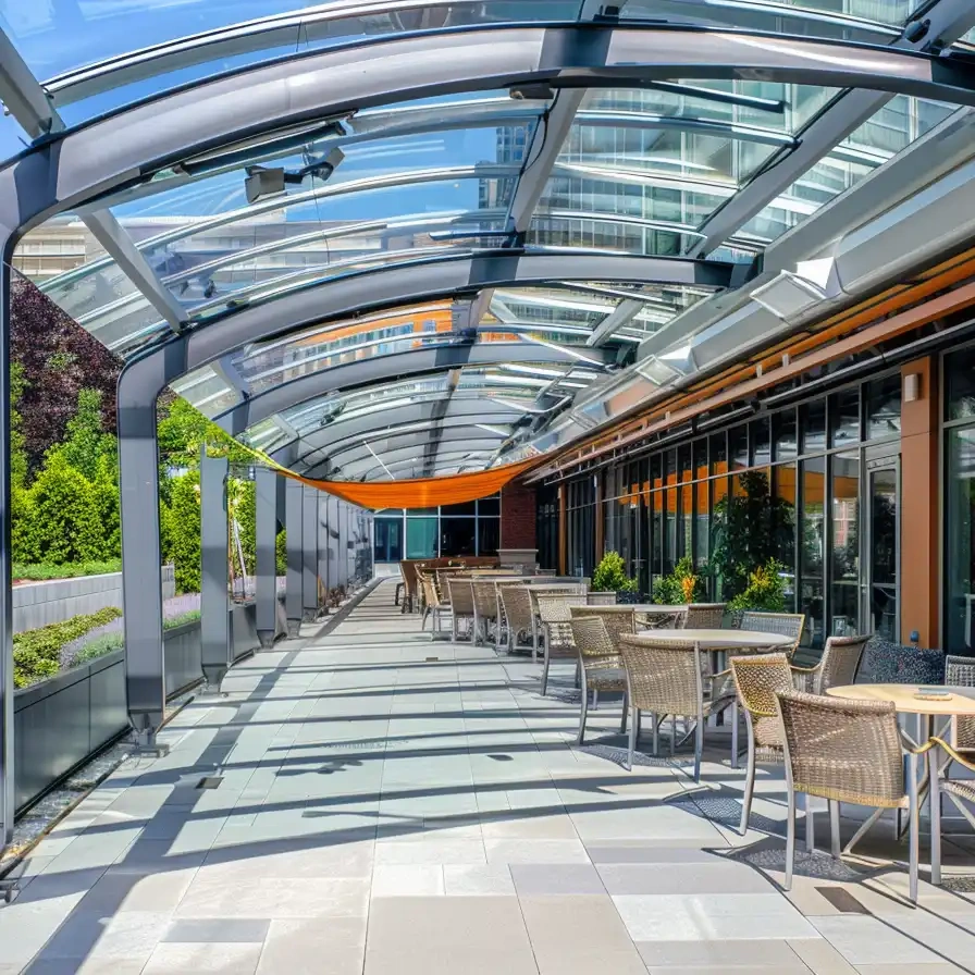 commercial outdoor patio enclosure with curved glass retractable roof system
