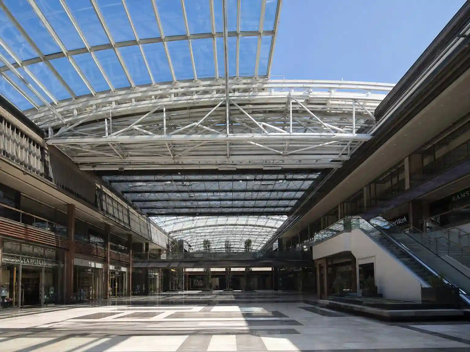 large commercial retractable glass roof installed in a shopping mall atrium