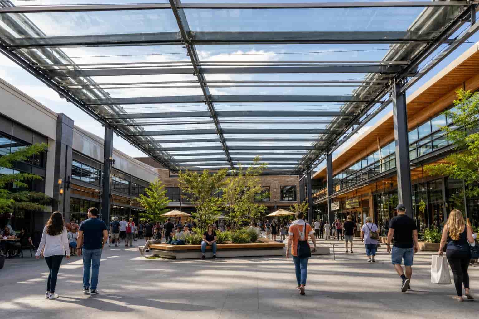 large commercial retractable roof structure covering shopping courtyard