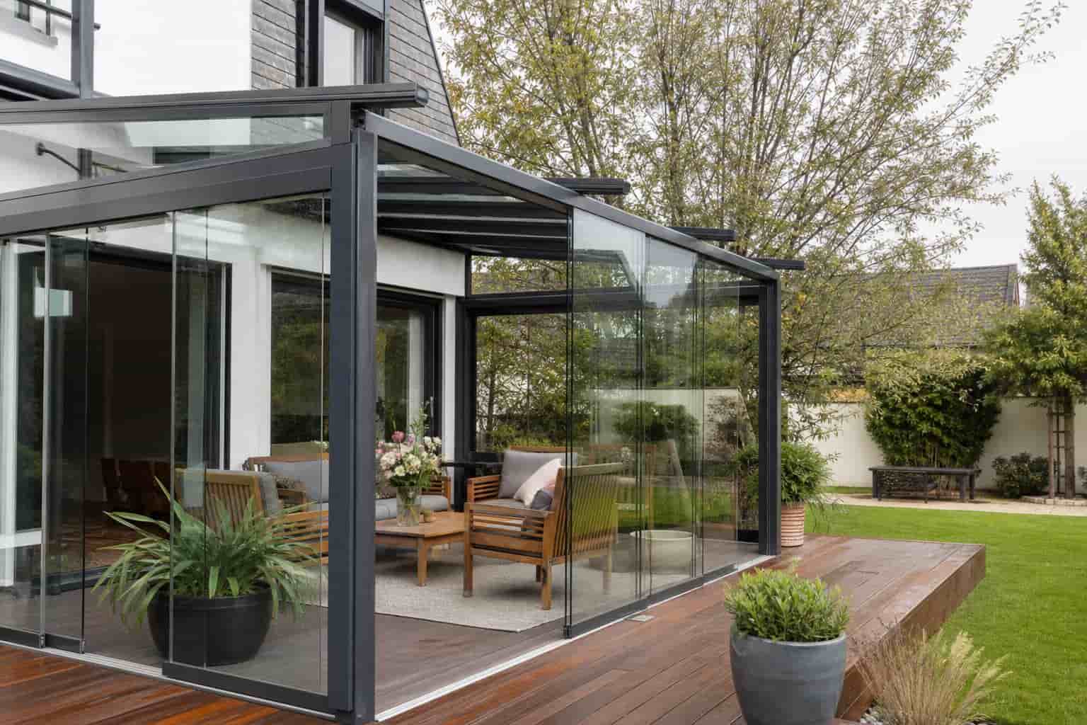 retractable sunroom installed on residential patio garden