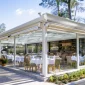 Retractable sunroom enclosure for scenic area outdoor restaurant