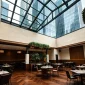 Glass roof courtyard for commercial building with transparent roof system