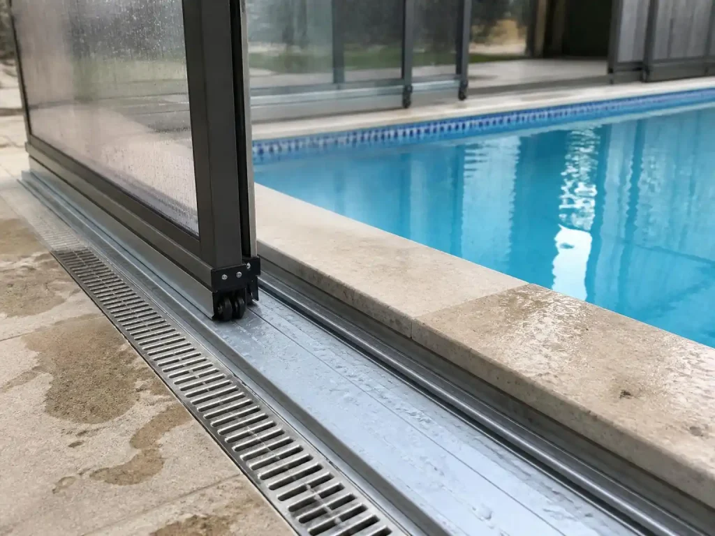 Track and foundation installation for retractable pool enclosure