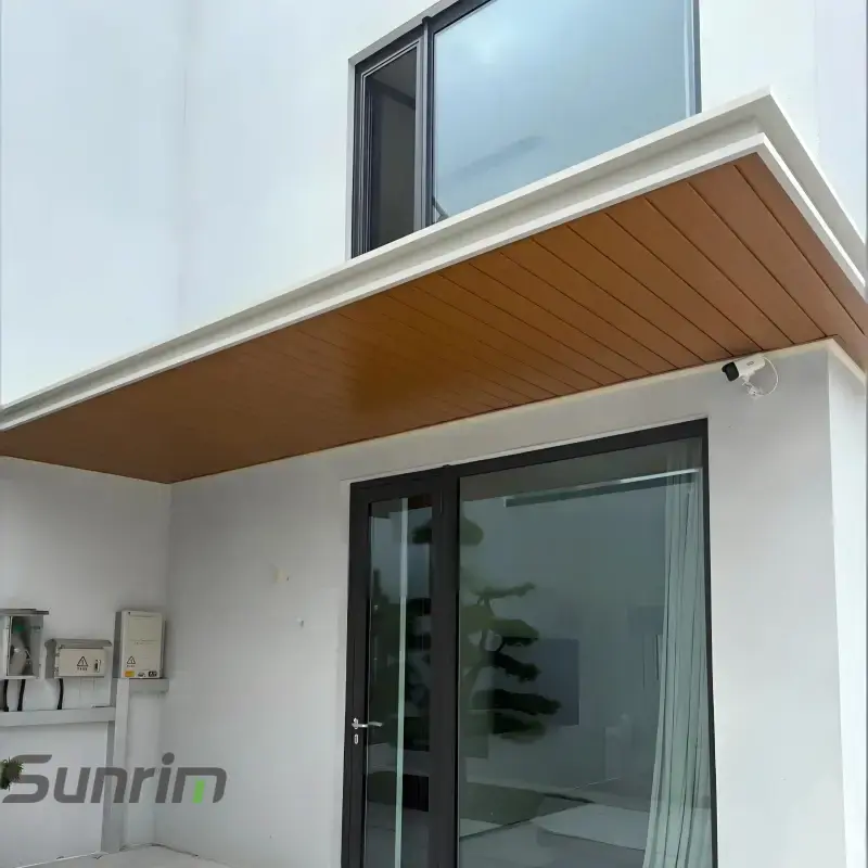 White frame aluminum door awning with light wood grain ceiling panels